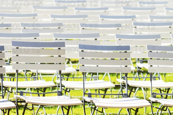 White chair rows in a spa park in black and white medium light