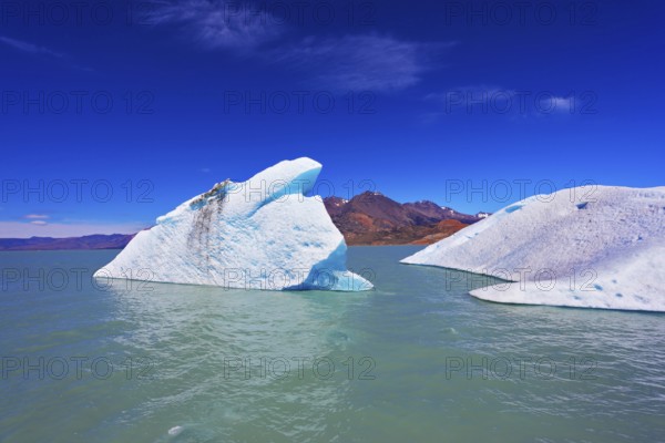 Huge white and blue icebergs floating in the icy water of emerald lake in Argentina. Unique lake Viedma in arid Patagonia