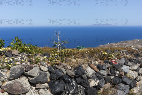 View from the crater hiking trail to an island in the sea, Santorini, Cyclades, Greece, Europe