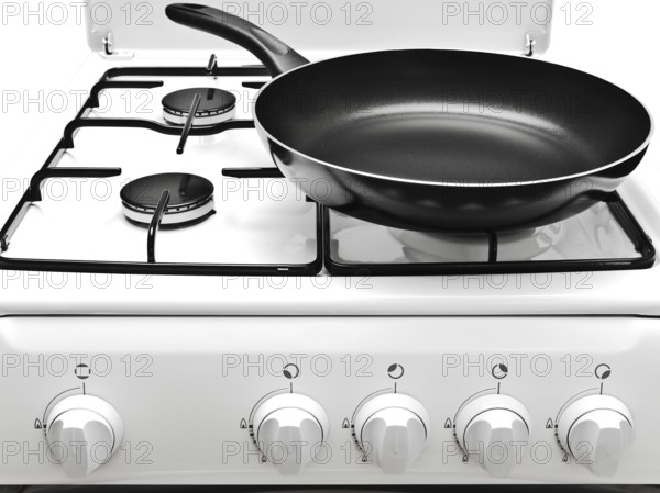 Frying Pan At The White Gas Stove Over The White Background