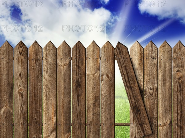 Wooden fence over the backyard with sky and sun