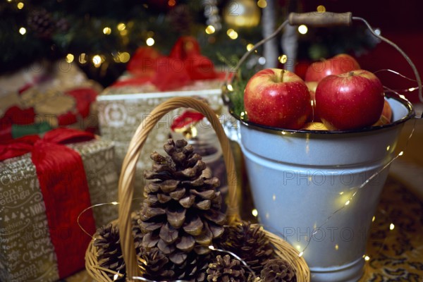 Christmas composition with red apples, gifts and gingerbread. Christmas in retro style. Vintage decoration. Cozy interior.