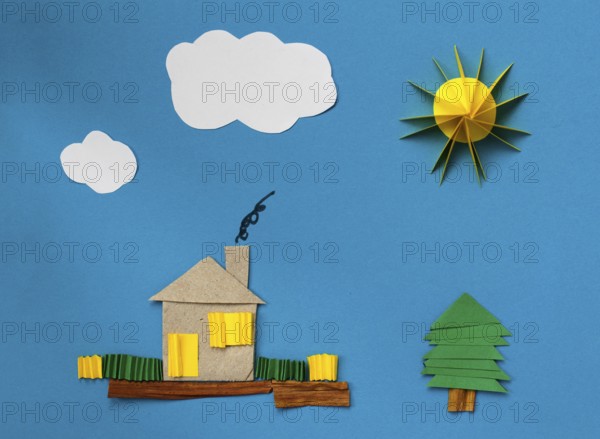 House made ??of paper over blue paper background