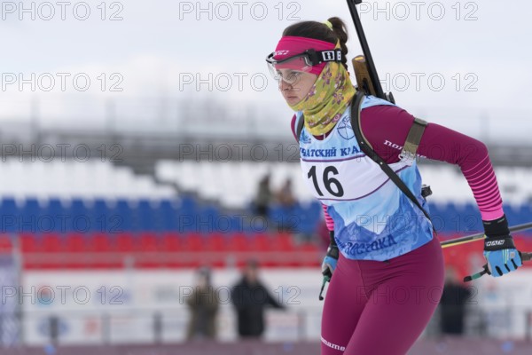 Kamchatka sportswoman biathlete Anastasia Ivchenko skiing on distance biathlon complex. Open regional youth biathlon competitions East Cup. Kamchatka Peninsula, Russian Far East, April 12, 2019