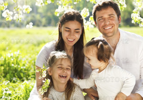 Happy young family with two children outdoors. Spring day