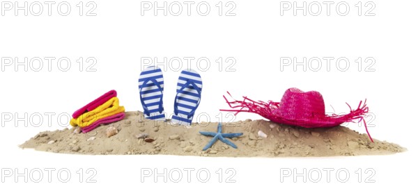 Beach with towels, flip flops and summer hat