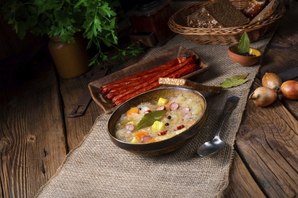 Rustic sauerkraut soup with bacon and sausage