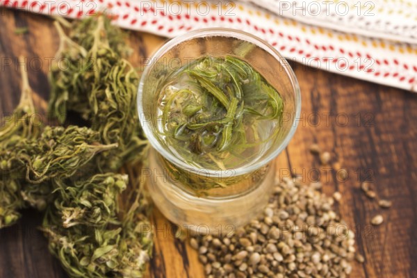 Cannabis herbal tea on wooden background