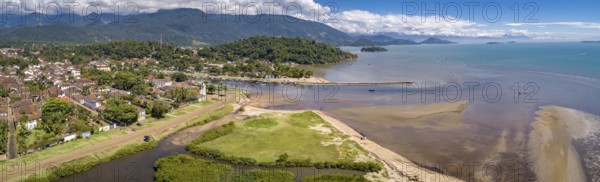 Panoramic aerial view to historic town Paraty, tidal river and Jabaquara with green mountains in background on a sunny day, Brazil, Unesco World Heritage, South America