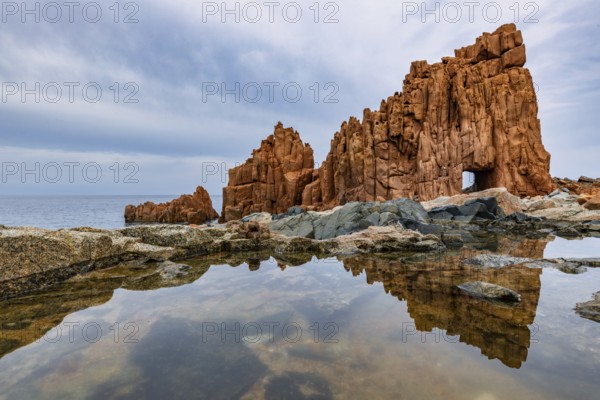 Rocce Rosse, the red rocks of Arbatax are reflected in a tidal pool, Arbatax, Tortoli, Ogliastra, Sardinia, Italy, Europe