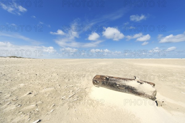 Wooden pole at the beach of Dutch wadden island Terschelling
