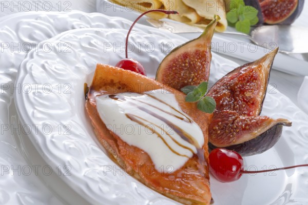 Flambiertes pfannkuchen mit feigen und kirschen