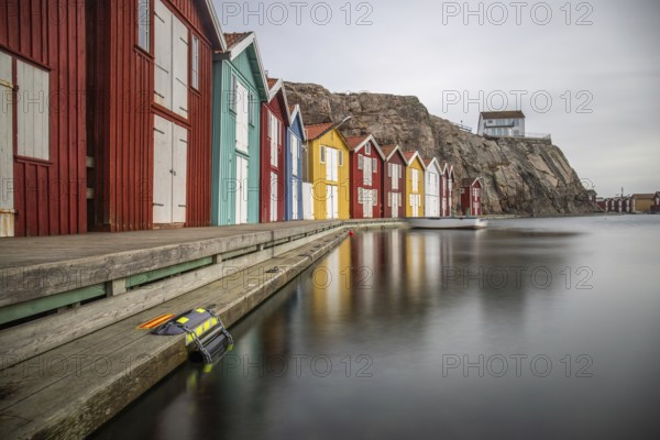 Small colourful houses by the sea. Typical houses in Sweden for the coastal landscape. Crab fishing and storage in a narrow harbour. Smögen, Smögenbryggan, Sweden, Europe
