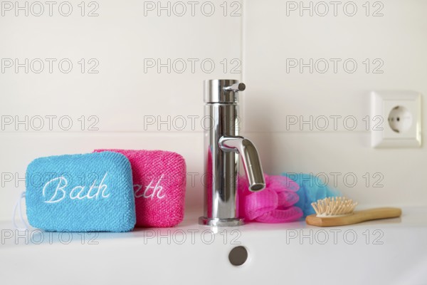 Bathroom with blue and pink sponges on sink