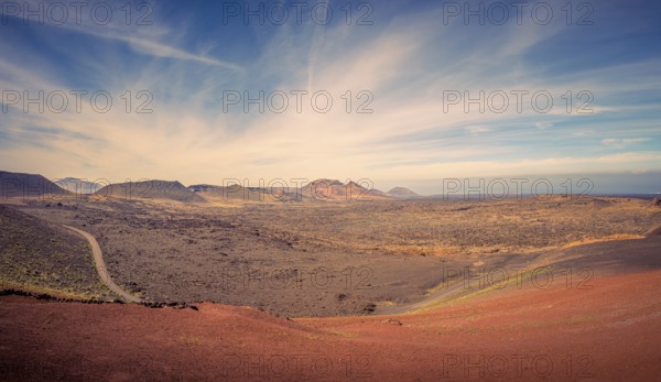 View on the desolate volcanic and moonlike landscape of Timanfaya National Park on Lanzarote, one of the Canary Islands of Spain and a famous travel destination for holidays