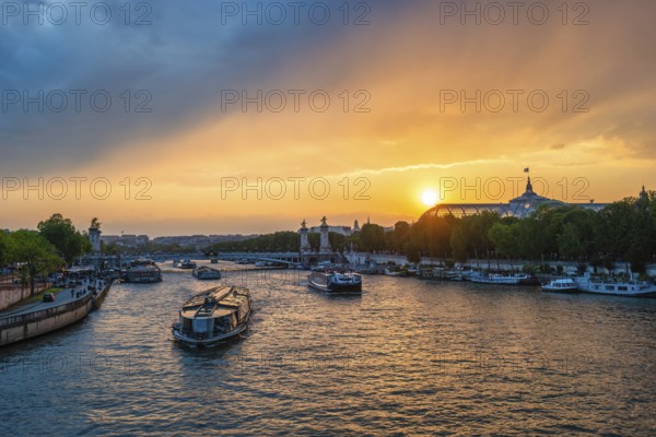 Paris France, city skyline sunset at Seine River with Pont Alexandre III bridge and Grand Palais