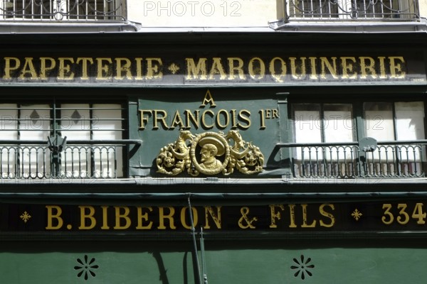 Shop front with golden letters on a green background. Landscape format. Front of a shop with golden letters on a green background. Horizontal format