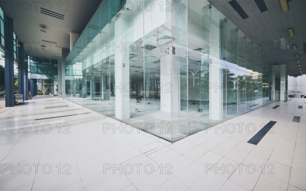 Modern empty office buildings with glass wall and empty pavement
