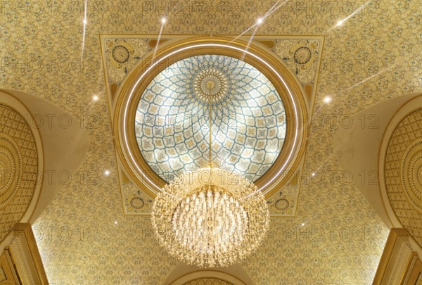 A picture of a chandelier in the ceiling of Qasr Al Watan