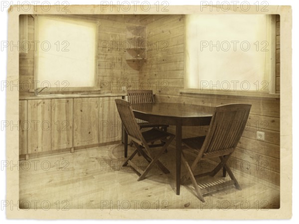 Old (stylized) photo of kitchen interior in a wooden blockhouse