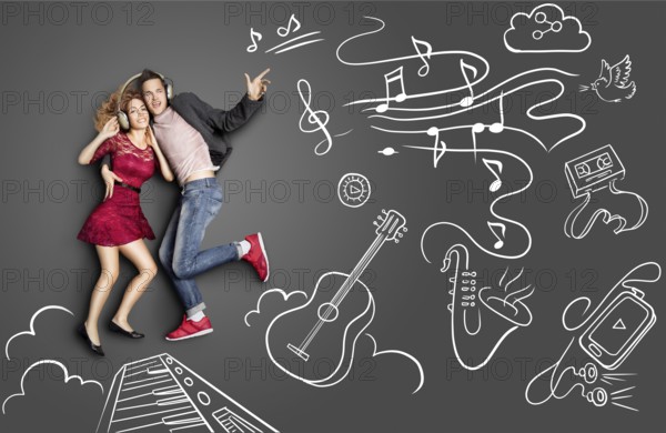 Happy valentines love story concept of a romantic couple sharing headphones and listening to the music against chalk drawings background of musical instruments