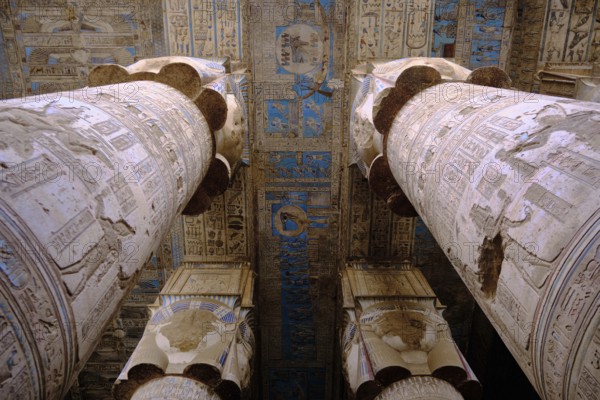 Colonnade at Hypostyle Hall of Temple of Hathor. Columns are decorated with reliefs and hieroglyphics. Dendera Temple complex, Qena, Egypt, Africa