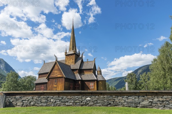 Lom stave church (Lom stavkyrkje) with graveyard foreground, Lom, Norway, Europe