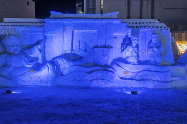 Taebeck, South Korea. January 29, 2019: Large snow sculpture depicting people in front of castle wall on display downtown during winter festival