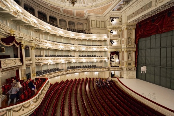 Semperoper, Dresden, Saxony, Germany, Europe, Magnificent interior of a historic theatre with red curtains and richly decorated architecture, Europe