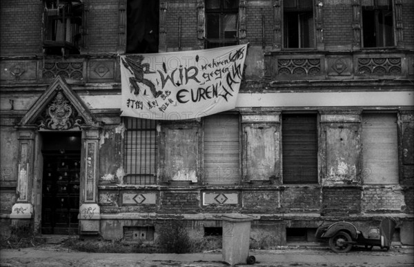 Germany, Berlin, 20 October 1991, Pfarrstraße, many houses in the street are occupied by autonomists (leftists), on the other side of the street there is an integration centre for neo-Nazis run by the church: We defend ourselves against your hatred, Europe