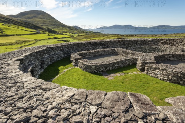 Loher Stone Fort at Caherdaniel overlooking green pastures and the sea under a clear blue sky, Ring of Kerry, Iveragh Peninsula, County Kerry, Ireland, Europe