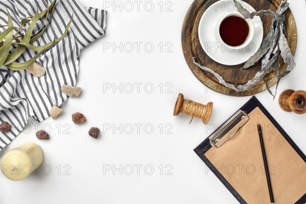Opened diary with pen on the table near hot cup of black tea. Top view, flat lay. Copy space. Still life