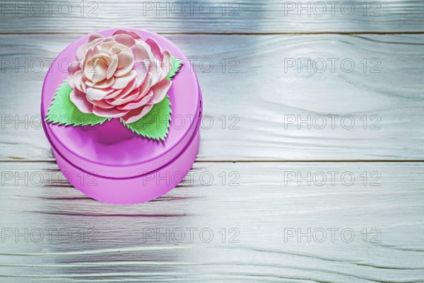 Round pink present box on wooden board celebrations concept