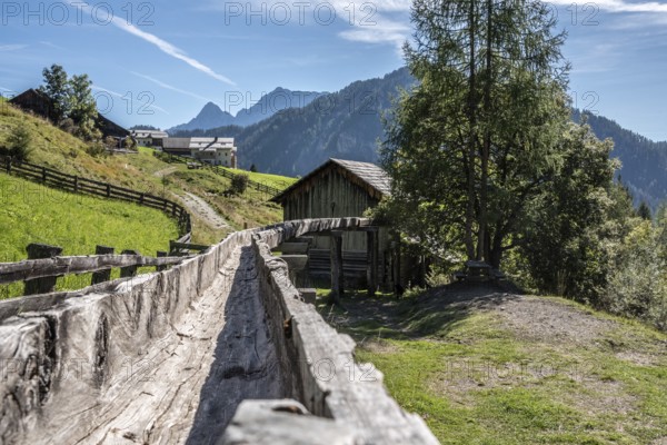 An old wooden inlet channel of a watermill in Val di Morins, the Dolomite Alps of South Tirol