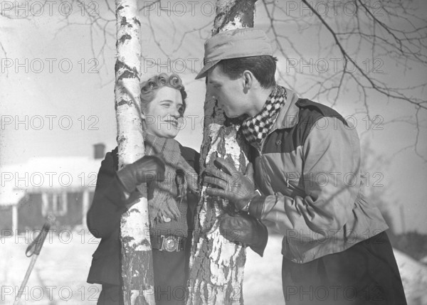 Winter in the 1940s. A young couple is enjoying their winter vacation, and they are wearing the typical winter fashion clothes of the 1940s. Sweden February 1940. Photo Kristoffersson Ref 68-9