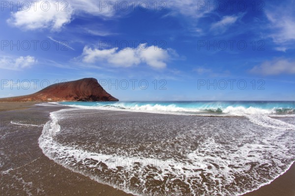 Beach Playa de la Tejita turquoise in Tenerife Canary islands with red mountain