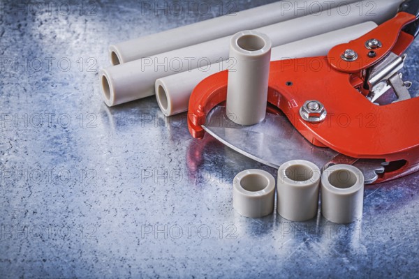 Set of pipe coupling tools on metallic background construction concept