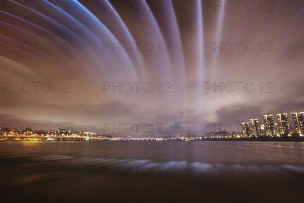 The famous Banpo Bridge is illuminated at night with water fountain display in Seoul, South Korea, Asia