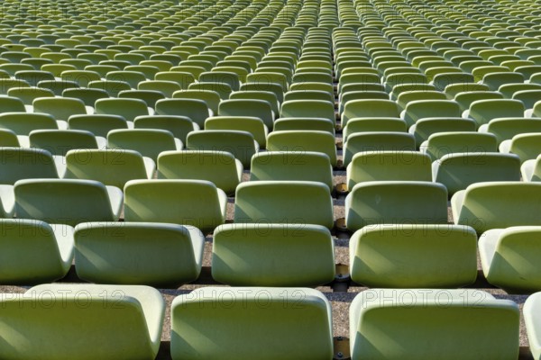 Many endless rows of enpty chairs in a stadium