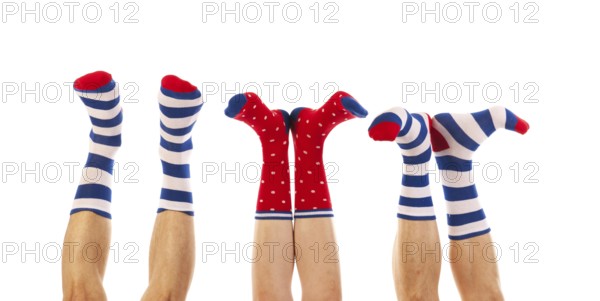 Feet in striped and dotted socks isolated over white background
