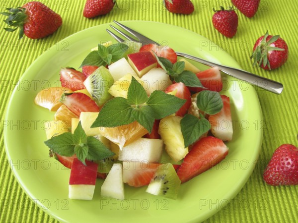 Fruit plate decorated with honeydew melon and sage