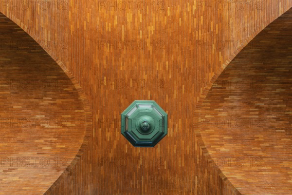Low angle view of brick vault and green lamp. Directly below view