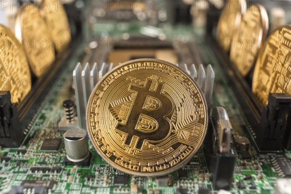 Bitcoin close-up on a computer circuit motherboard as a blockchain technology payment network. Digital cryptocurrency concept and mining