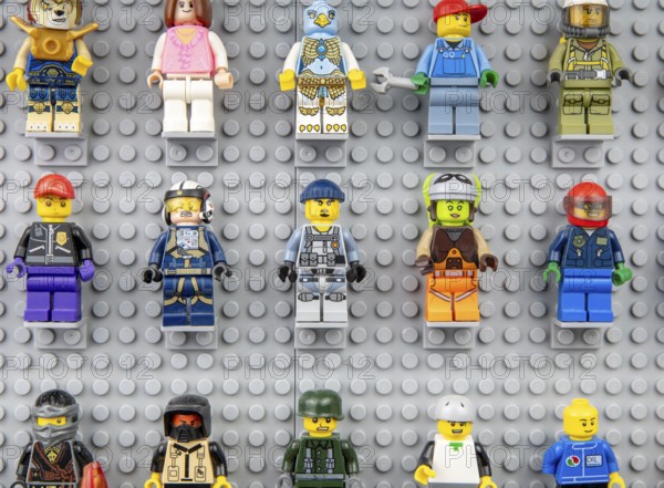 Nova Bana, Slovakia, November, 5, 2023 : Lego mini figures on the wall. LEGO® Minifigures on Lego baseplates in a row, Europe