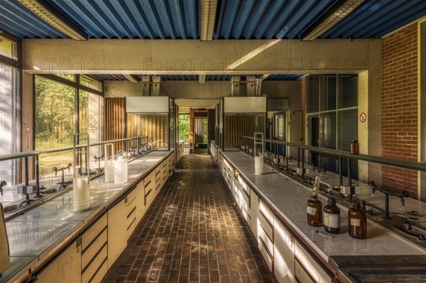 A large abandoned laboratory with numerous empty tables and glass bottles on them, Institute of Molecular Biology, Lost Place, Sint-Genesius-Rode, Province of Flemish Brabant, Belgium, Europe