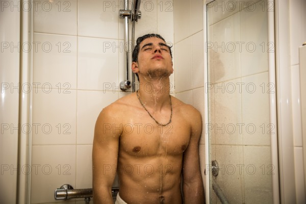 Close up Attractive Young Bare Muscular Young Man Taking Shower, Looking Down