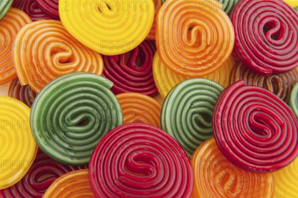Colorful licorice candy drop rolls as background