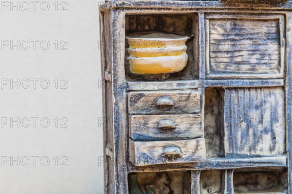 Gongju, South Korea, August 5, 2019: Closeup of miniature piece of kitchen furniture against white background, Asia