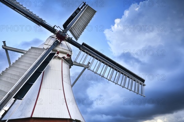 White Dutch windmill over blue sky via wide angle, Holland
