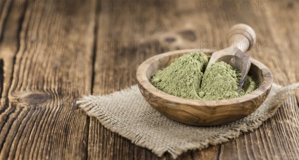 Stevia leaf powder (detailed close-up shot) on rustic wooden background